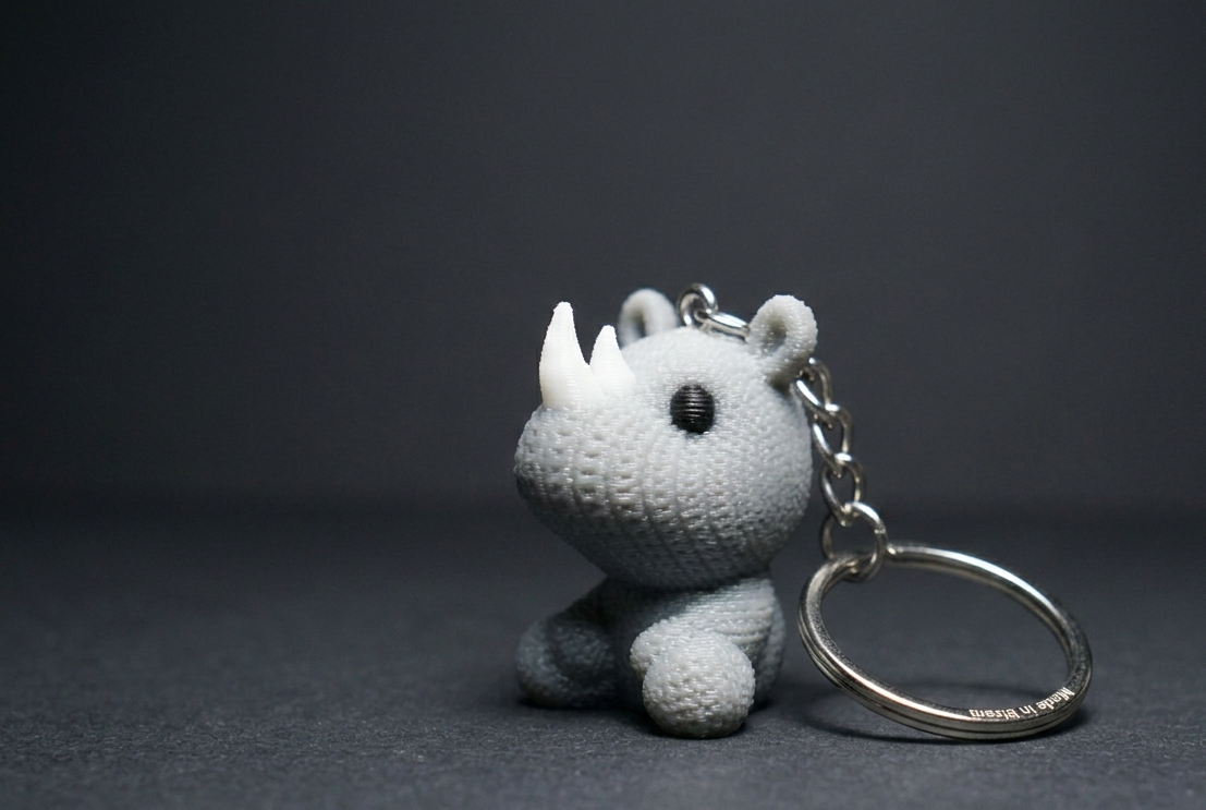 White rhinoceros keychain on a dark gray background
