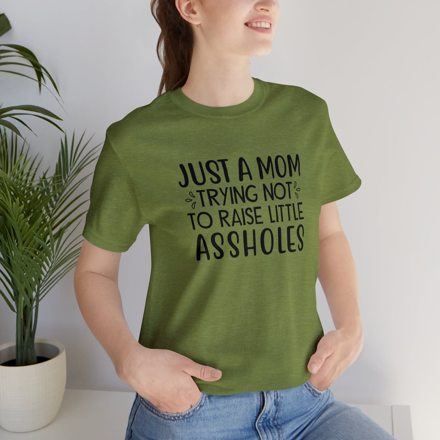 Just a mom trying not to raise little assholes Unisex Jersey Short Sleeve Tee