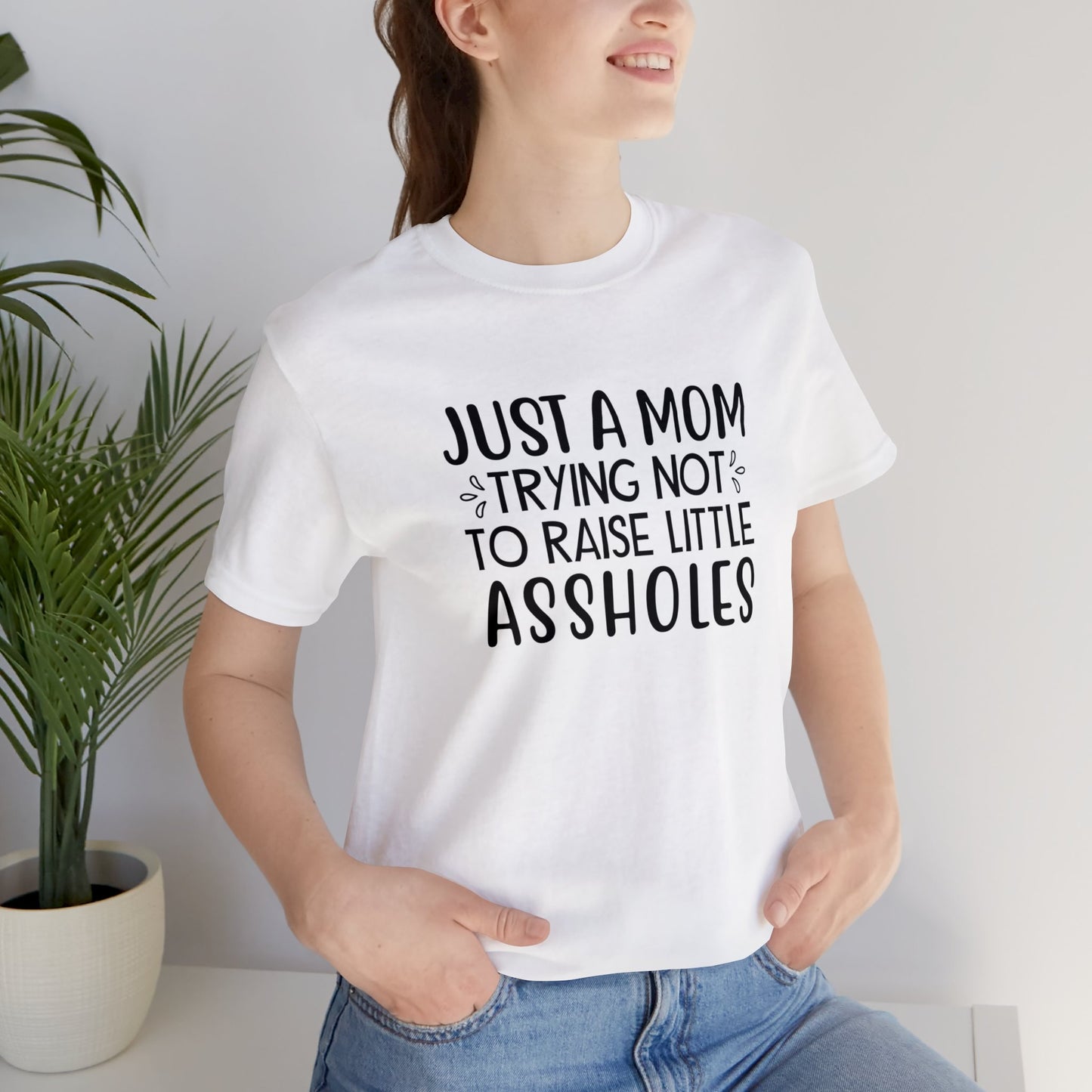 Just a mom trying not to raise little assholes Unisex Jersey Short Sleeve Tee