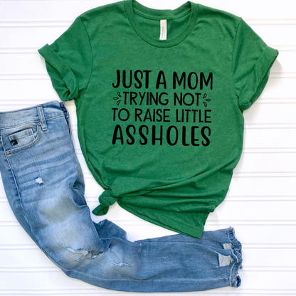 Just a mom trying not to raise little assholes Unisex Jersey Short Sleeve Tee