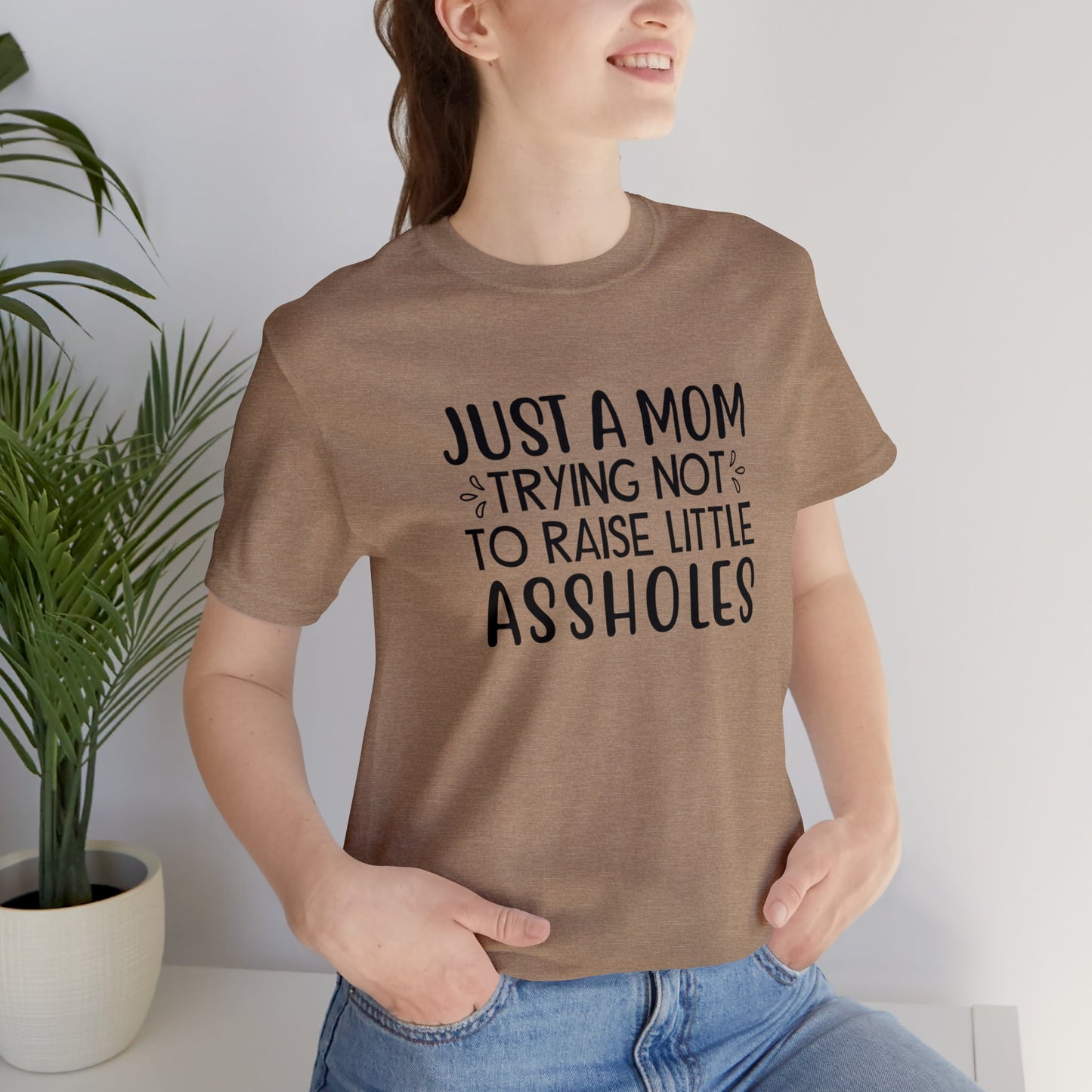 Just a mom trying not to raise little assholes Unisex Jersey Short Sleeve Tee