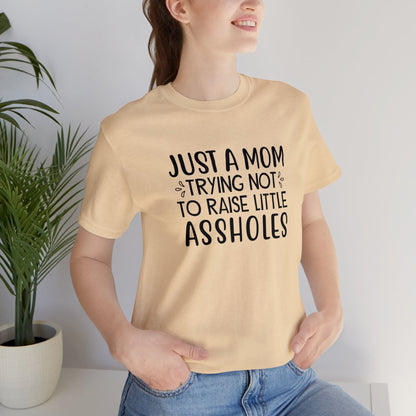 Just a mom trying not to raise little assholes Unisex Jersey Short Sleeve Tee